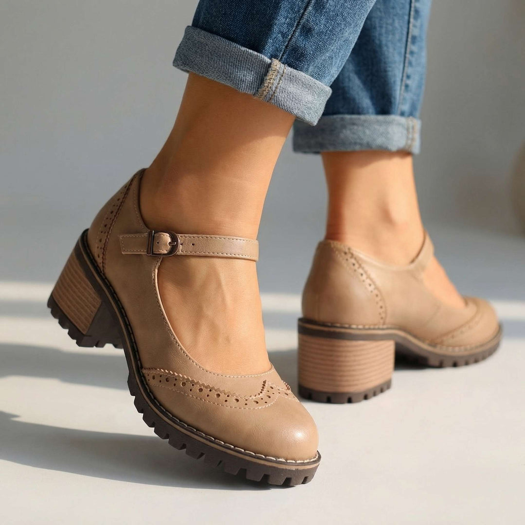 Beige brogue Mary Jane heels with ankle strap and textured platform sole