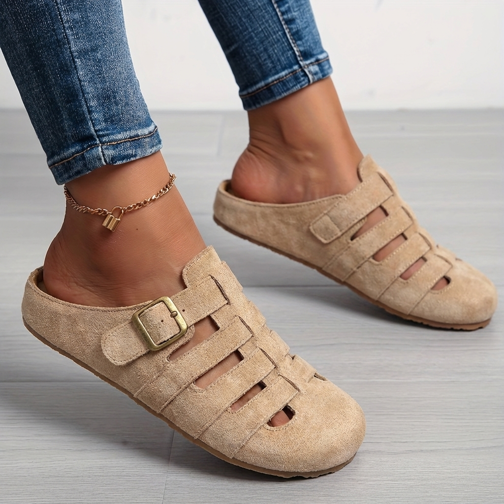 Beige suede buckle mule sandals styled with rolled-up denim jeans