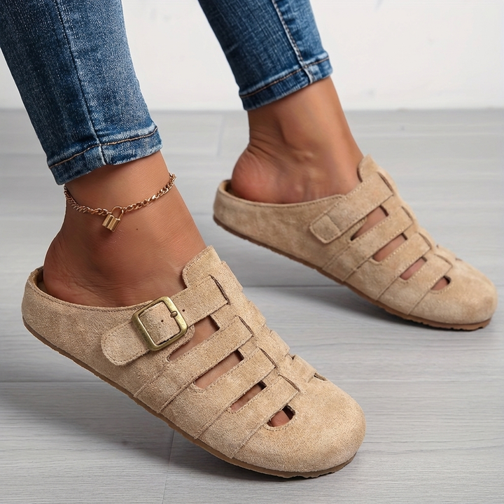 Beige suede buckle mule sandals styled with rolled-up denim jeans