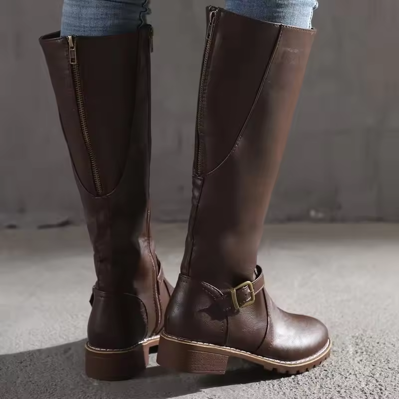 Rear view of brown leather knee-high boots showing zip and buckle trim