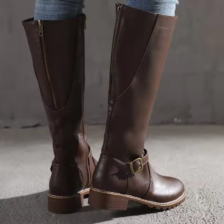Rear view of brown leather knee-high boots showing zip and buckle trim