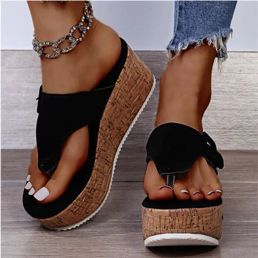Black toe-post cork wedge sandals with buckle strap and platform sole