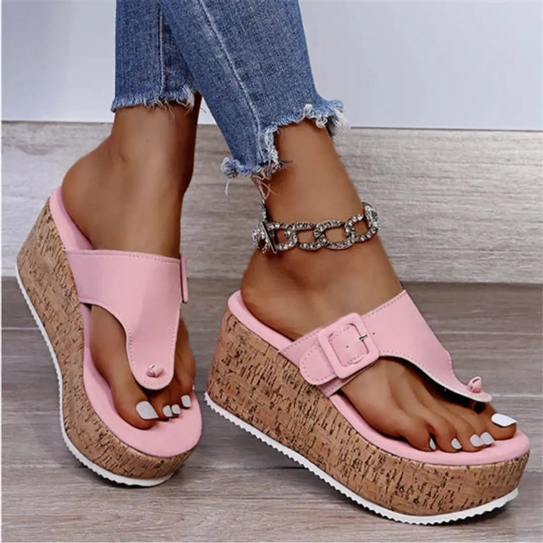 Pink toe-post cork wedge sandals with buckle strap and chunky platform