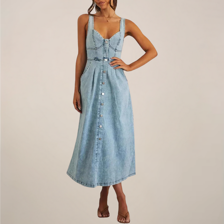 Light-wash sleeveless denim midi dress styled with strappy heeled sandals