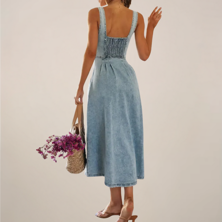 Rear view of denim midi dress showing smocked back panel and A-line skirt