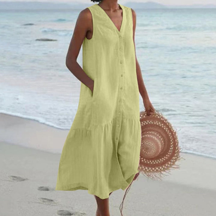 Pastel green sleeveless linen shirt dress featuring button placket and side pockets