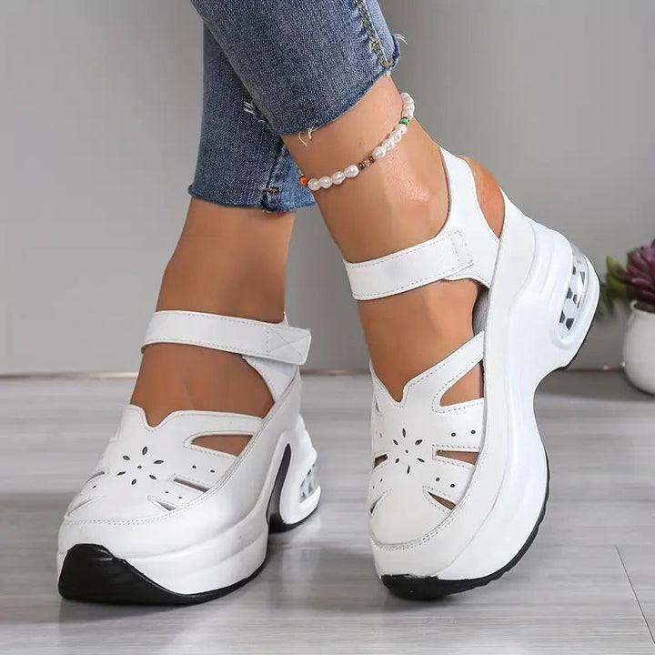 White chunky platform sandals with cut-out detailing and ankle strap fastening