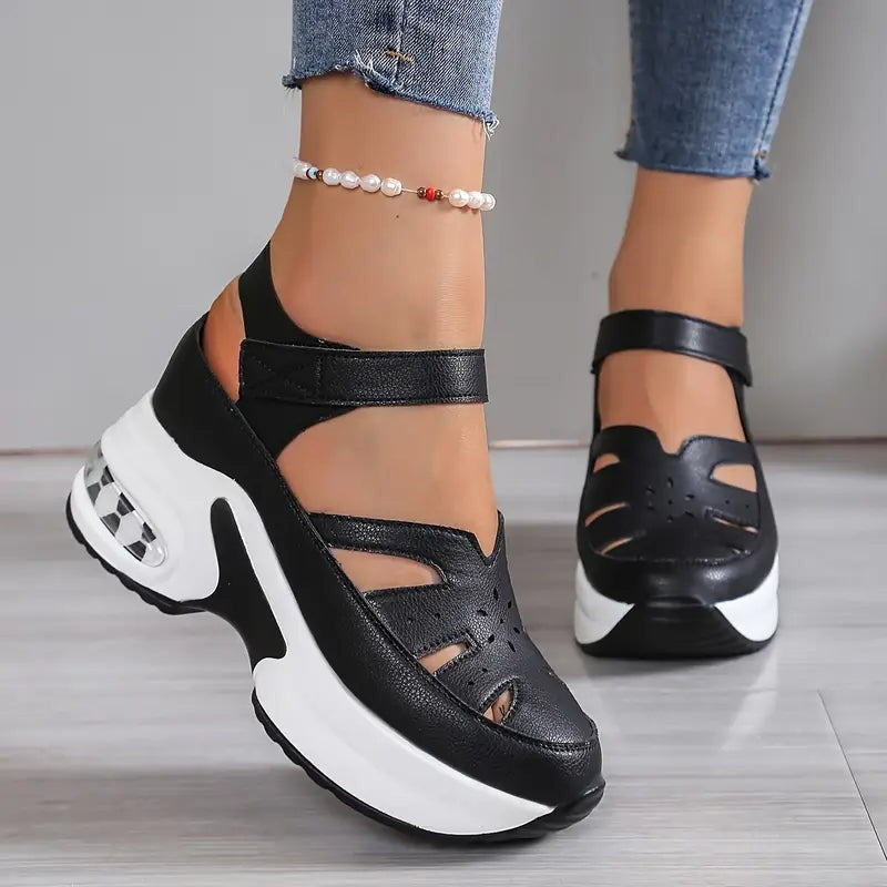 Black and white chunky wedge sandals with closed toe and cut-out sides