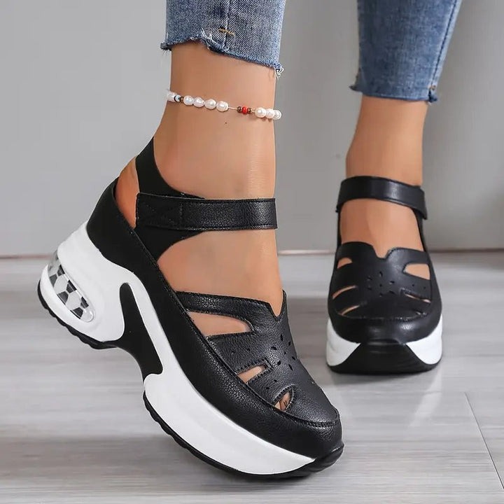 Black and white chunky wedge sandals with closed toe and cut-out sides