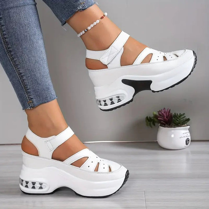 White platform sandals with side cut-outs and adjustable ankle strap