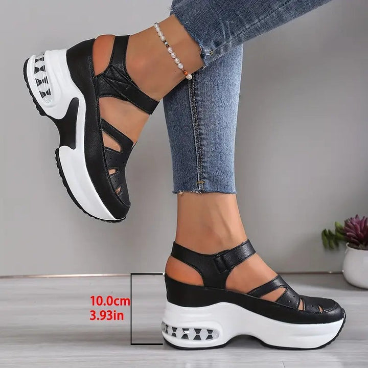 Black chunky wedge sandals with strappy cut-out design and thick platform sole