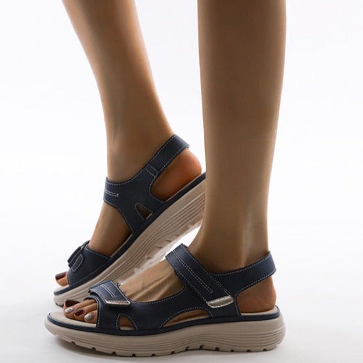Navy blue flat sandals with adjustable straps and chunky platform sole