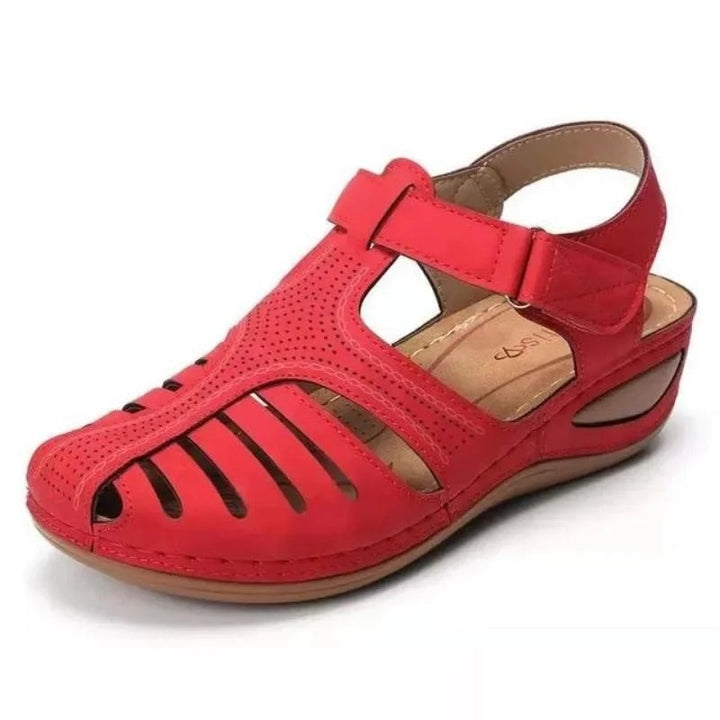 Red closed-toe wedge sandal with cut-out design and touch-fastening strap