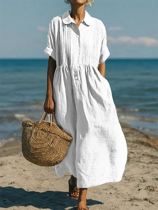 White linen shirt dress with pintuck detail worn on a beach walk