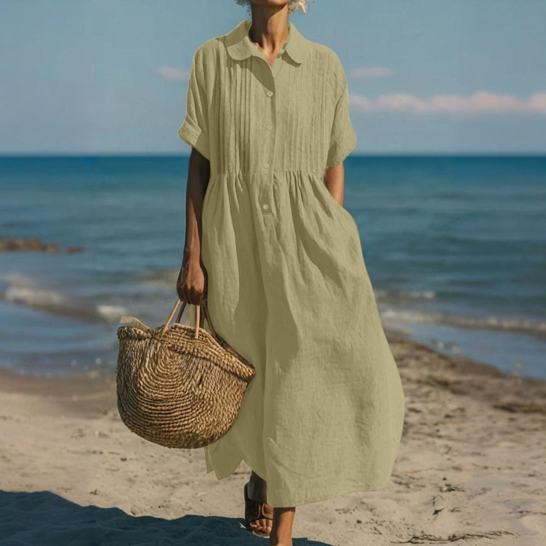 Sage green button-front midi dress with pintuck detail on the seashore