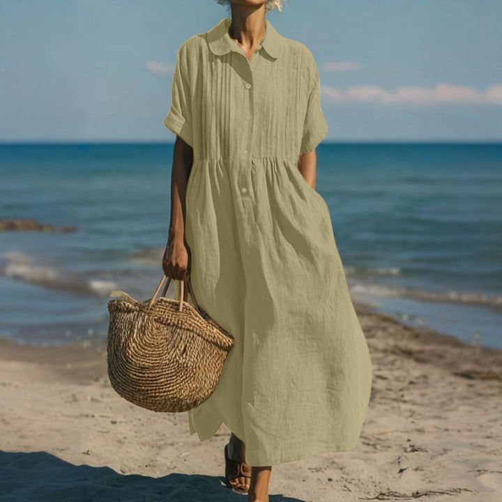 Sage green button-front midi dress with pintuck detail on the seashore