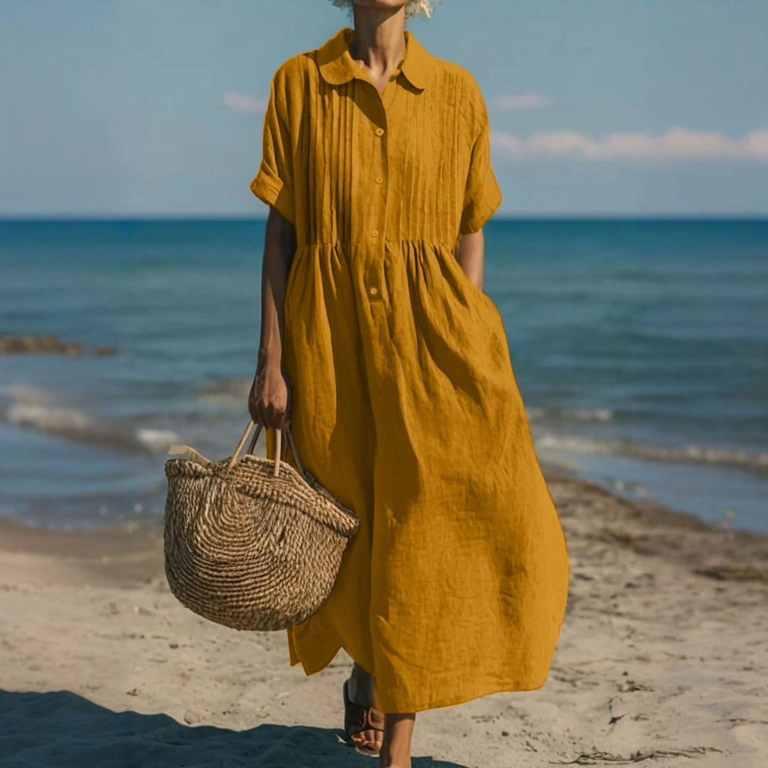 Mustard yellow button-front midi dress with pleated collar at the coast