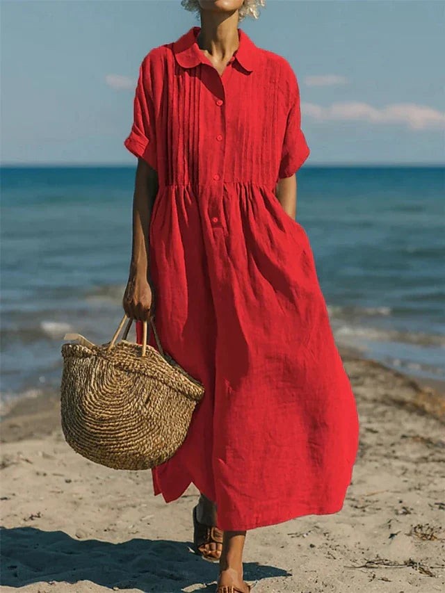 Red collared shirt dress with pintuck bodice paired with a straw tote