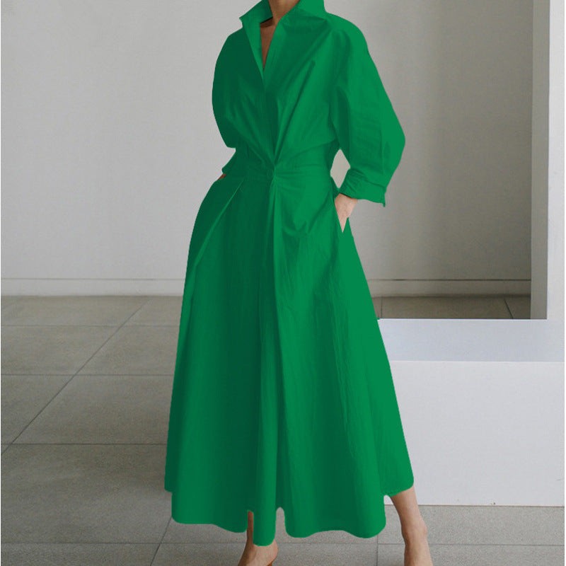 Green collared maxi dress with cinched waist and flowing pleated skirt