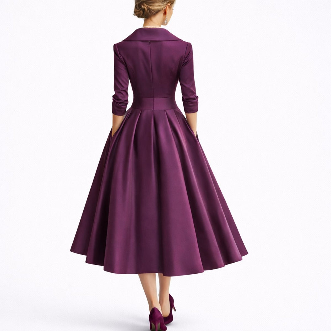 Back view of plum satin midi dress with fitted waist and swing skirt