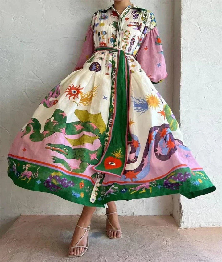 Flowing maxi dress with dragon and star print, cinched with green tie belt