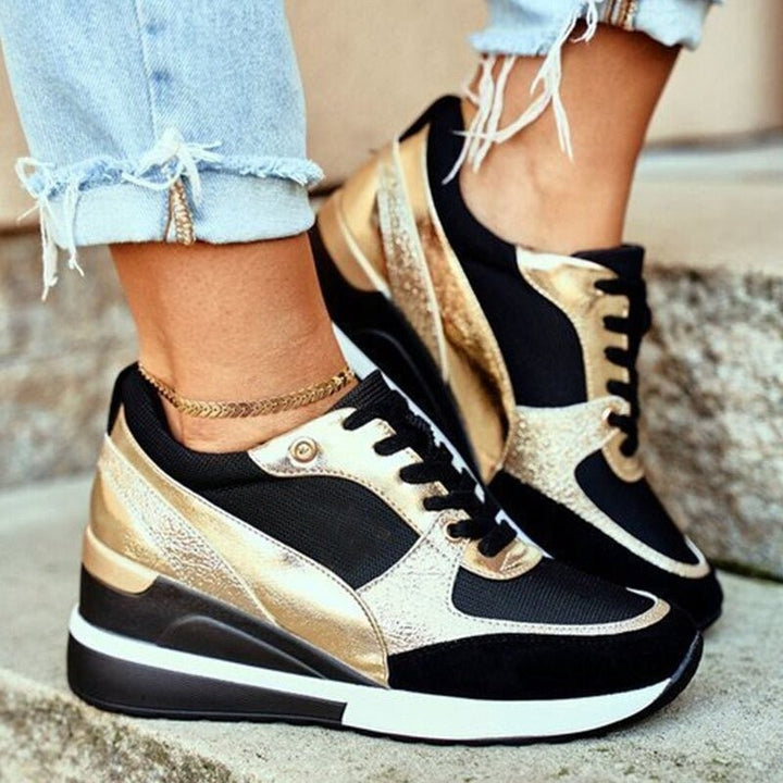 Black and gold lace-up wedge trainers with metallic panel detailing