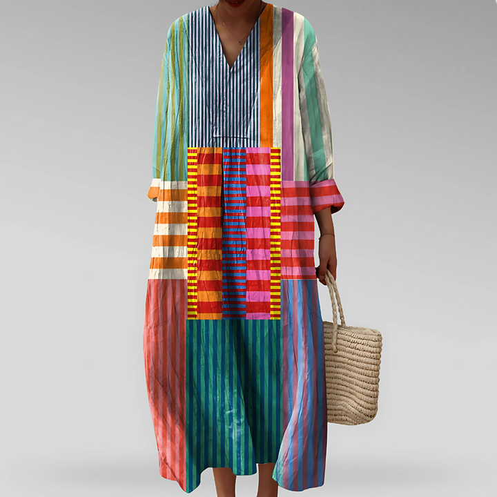 Patchwork striped maxi dress with V-neck, paired with a woven straw handbag
