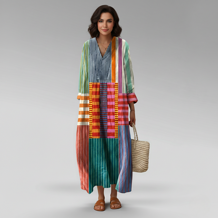 Long-sleeve patchwork maxi dress featuring bold striped panels and a relaxed V-neckline