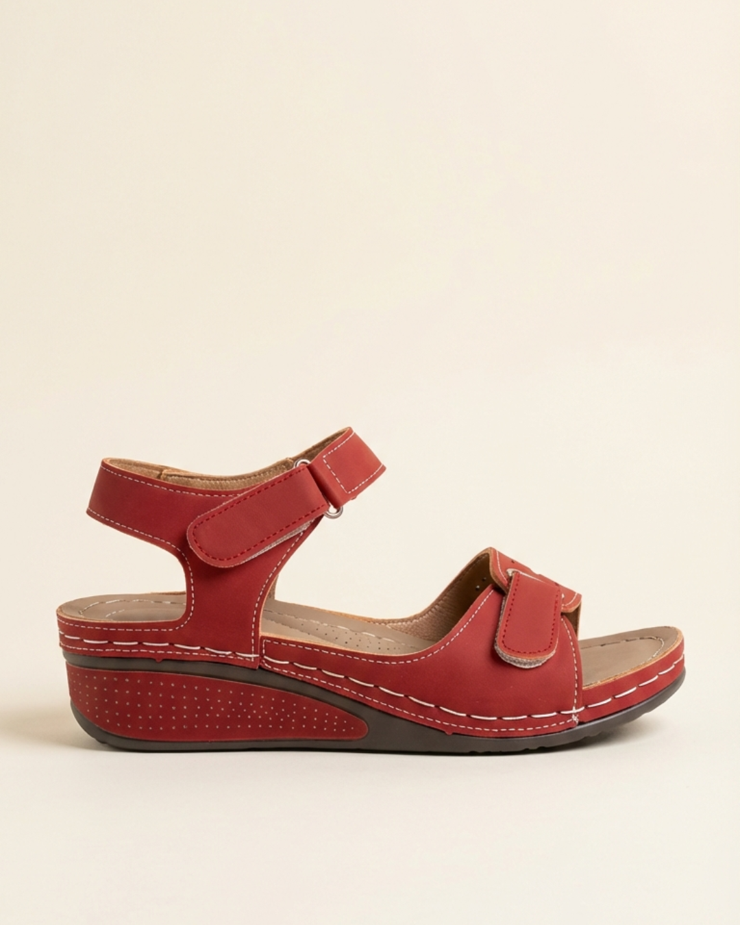Deep red wedge sandal with contrast stitching and touch-fastening ankle strap