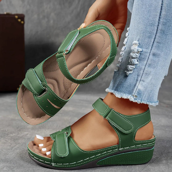 Green wedge sandals with adjustable straps and contrast stitching detail