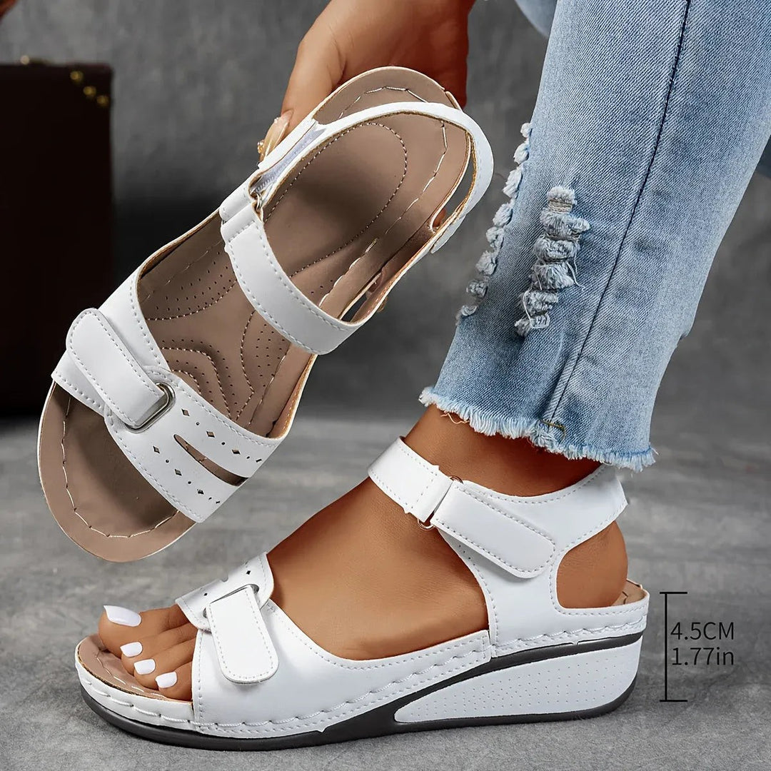 White orthopedic wedge sandals with measurement label showing heel height