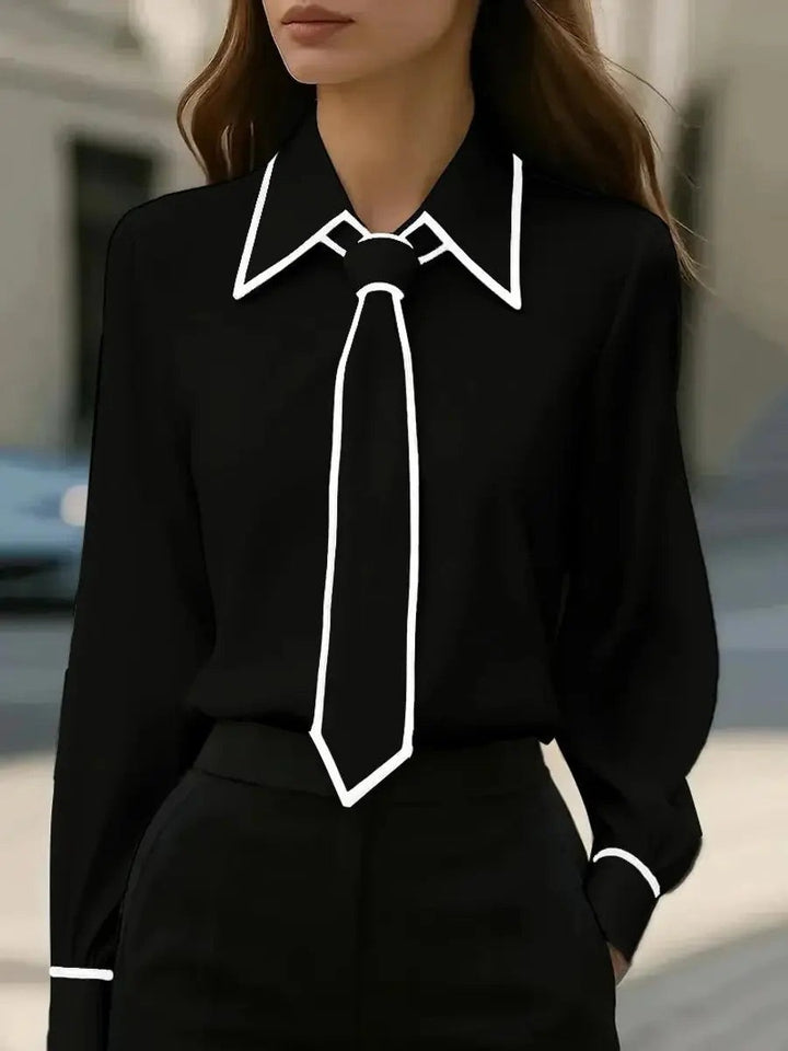 Black tie-neck blouse with contrasting white trim on collar and cuffs