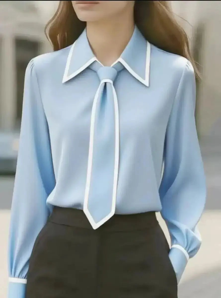 Pale blue button-down blouse with white contrast trim and tie-neck styling