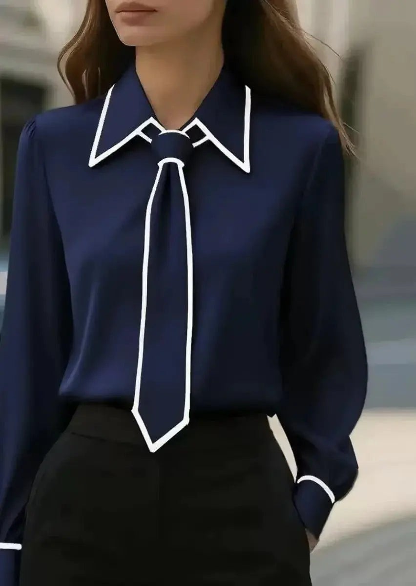 Navy blouse featuring white piped collar and matching tie-neck detail