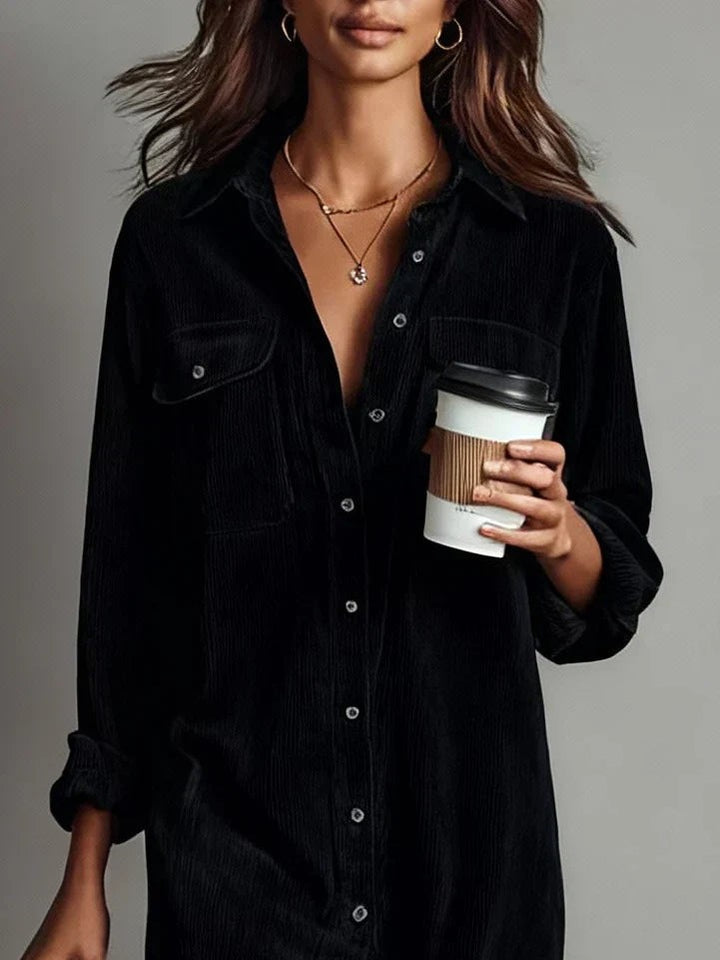 Black corduroy shirt dress close-up showing collar and buttoned front