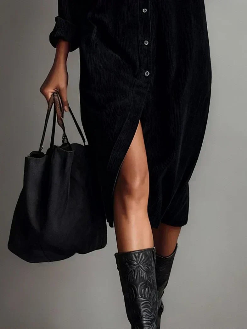 Black corduroy midi dress hem detail with front slit and ankle boots