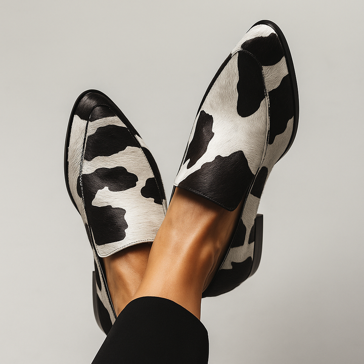 Cow-print pony hair loafers with pointed toe and black trim