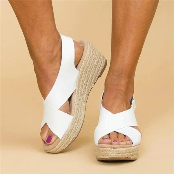 White crossover strap espadrille wedge sandals worn on bare feet