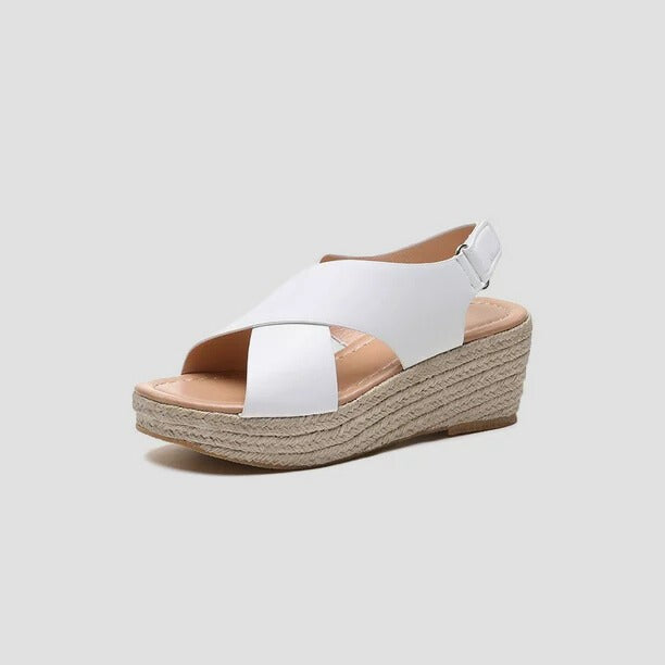 White leather crossover wedge sandal displaying jute-wrapped platform heel