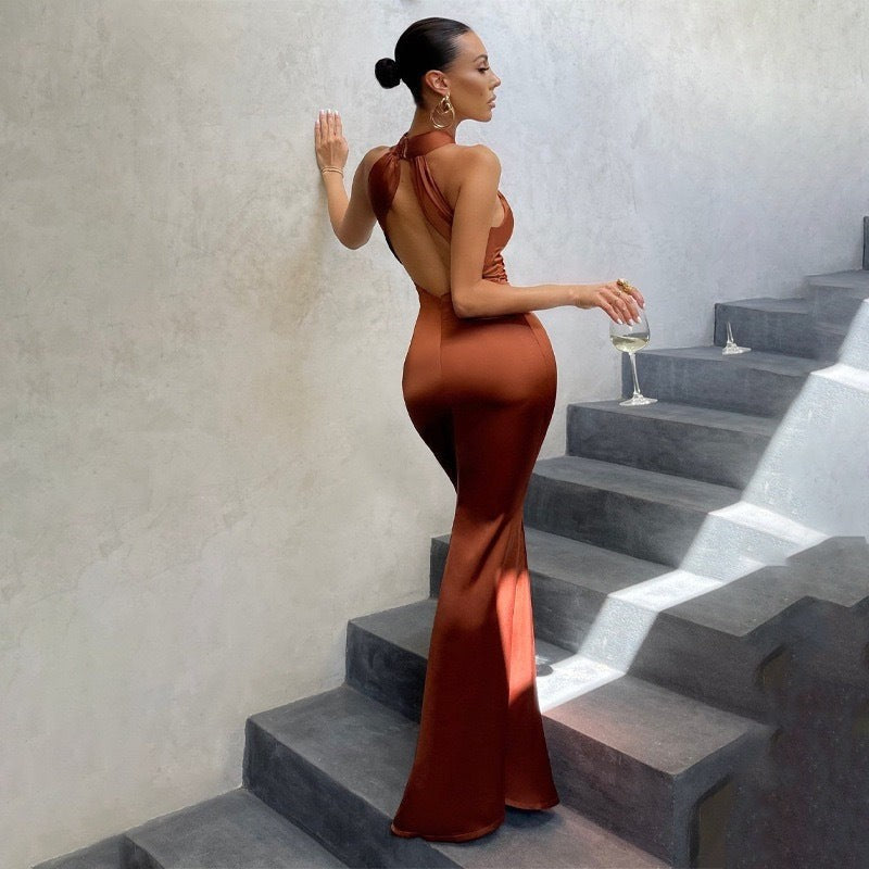 Rust satin backless maxi dress showing fitted mermaid hem from behind