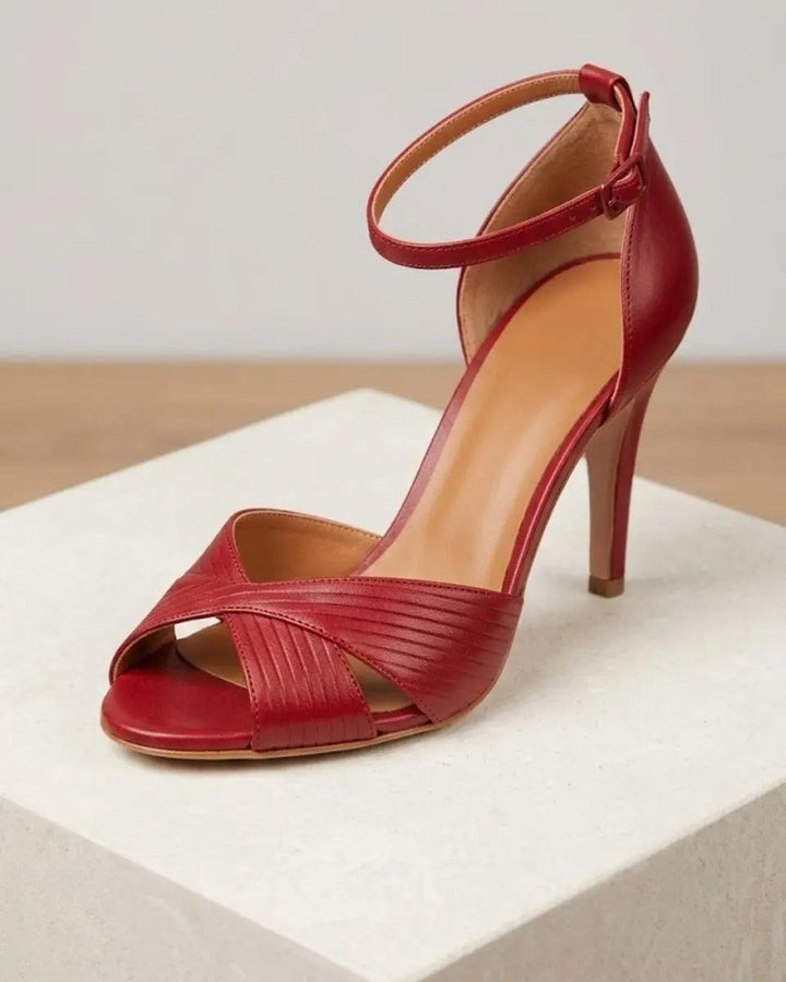 Red leather stiletto sandal with crossover peep toe and buckled ankle strap