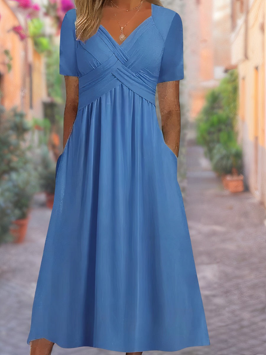 Blue midi dress featuring wrap-style V-neckline and flowing skirt