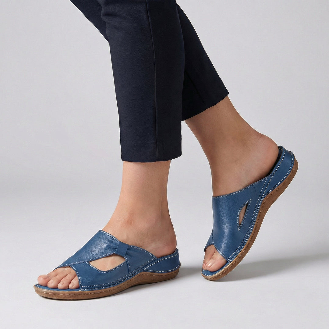 Blue leather open-toe slide sandal featuring cushioned sole and stitched trim