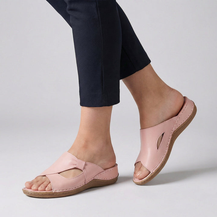 Pink leather comfort slide sandal with woven cross strap and cut-out design