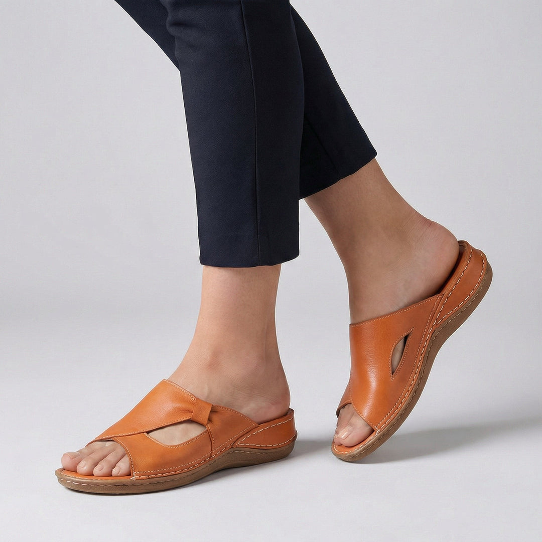 Tan leather orthopedic slide sandal showing contrast stitching and open toe