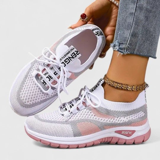 White mesh trainers with pink detailing and lace-up breathable upper