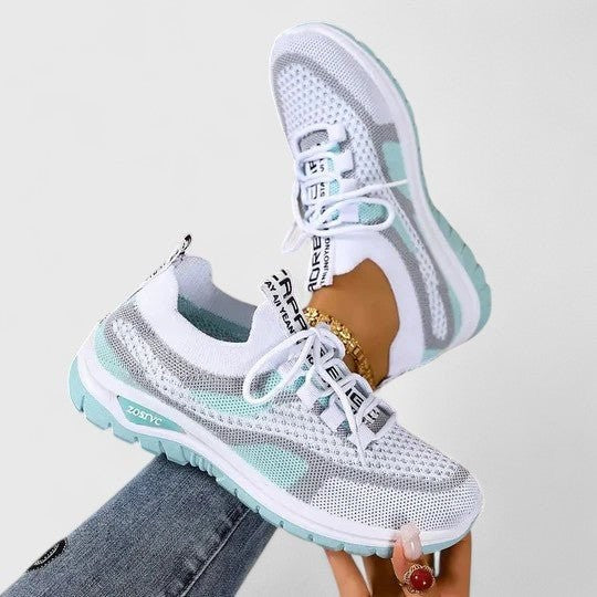 White mesh trainers with mint green trim and knitted lace-up upper