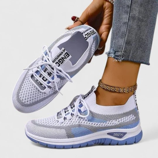 White mesh trainers with pale blue accents and breathable lace-up design