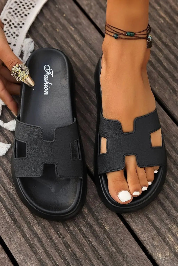 Black H-strap platform sandals displayed flat and worn for comparison
