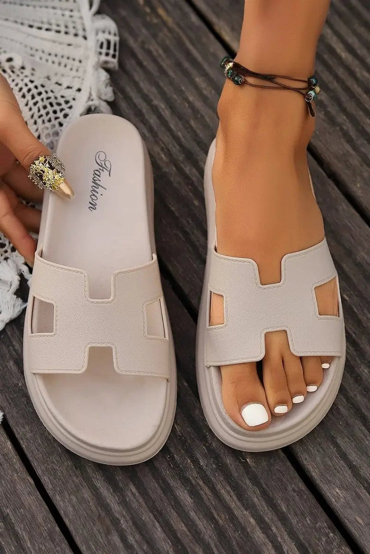 Beige H-strap platform sandals shown flat lay and worn together